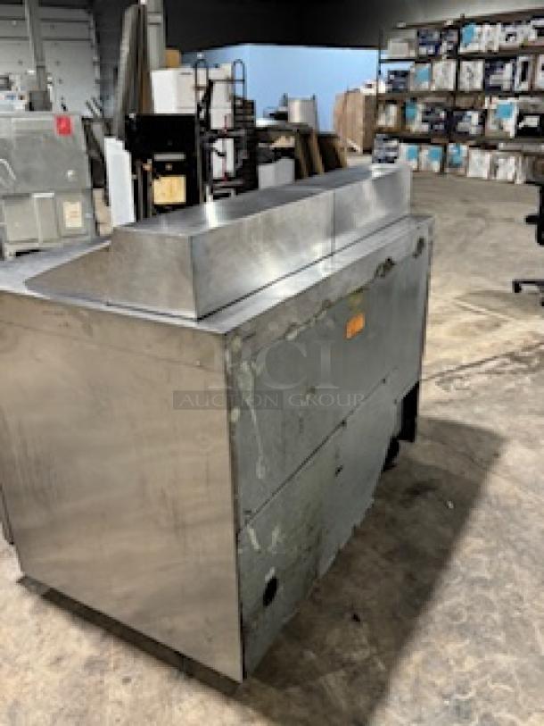 Delfield 4464NP-16 64" refrigerated sandwich prep table, stainless steel, with 2 doors and 3" casters, tested and working.