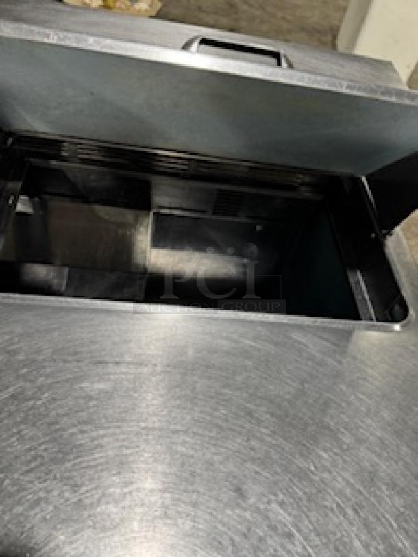 Delfield 4464NP-16 refrigerated sandwich prep table, 64", stainless steel, open lid view, shows interior compartments.