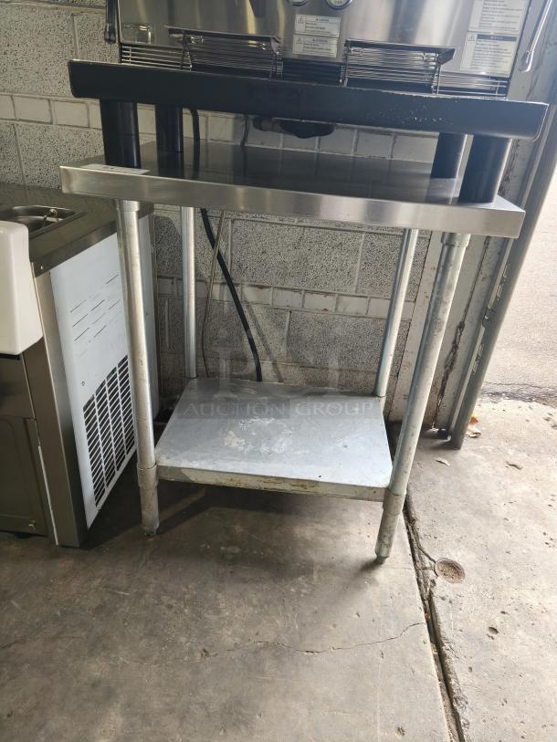 Regency 30" x 36" stainless steel work table with undershelf, 16-gauge 304, wear visible, sturdy commercial quality.