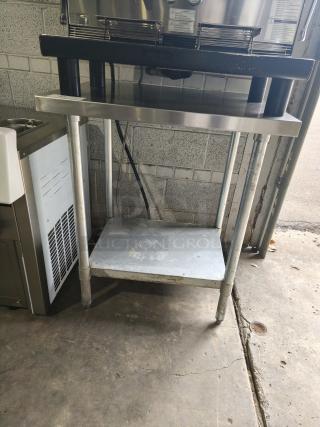 Regency 30" x 36" stainless steel work table with undershelf, 16-gauge 304, wear visible, sturdy commercial quality.