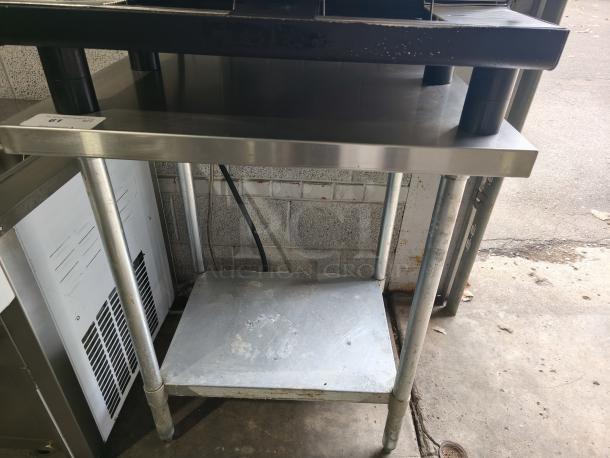Regency 30"x36" stainless steel work table with undershelf, model 304. Features 16-gauge 304 steel, durable construction. Slight wear.