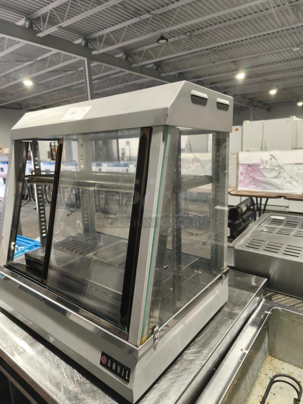 Anvil hot curved countertop display cabinet, model DGH0540. Tested, working, missing glass, visible Anvil logo, stainless steel.