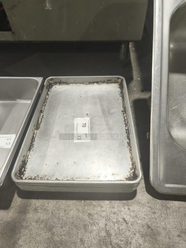 Commercial heavy-duty aluminum half-sheet pan, used condition, visible signs of wear and rust, quantity label showing "QTY 5".