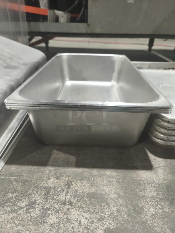 Commercial stainless steel 1/3 size hotel pan in good condition, featuring a smooth finish and durable construction.