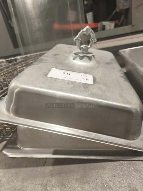 Commercial stainless steel 1/3-size hotel pan cover with decorative handle, used condition, label “75, QTY x2.”