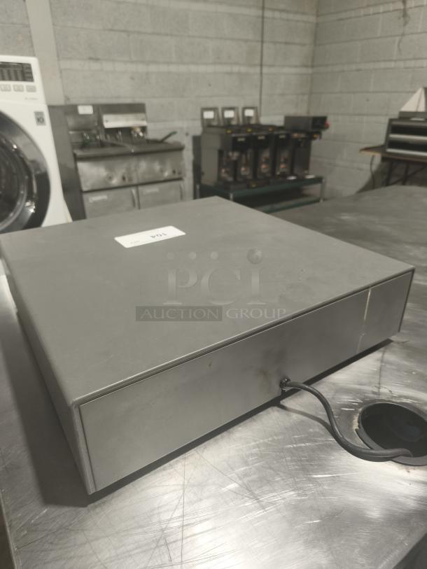 Heavy-duty steel POS cash drawer, durable design, features cable connection, unidentified model, used condition, label reads "104".