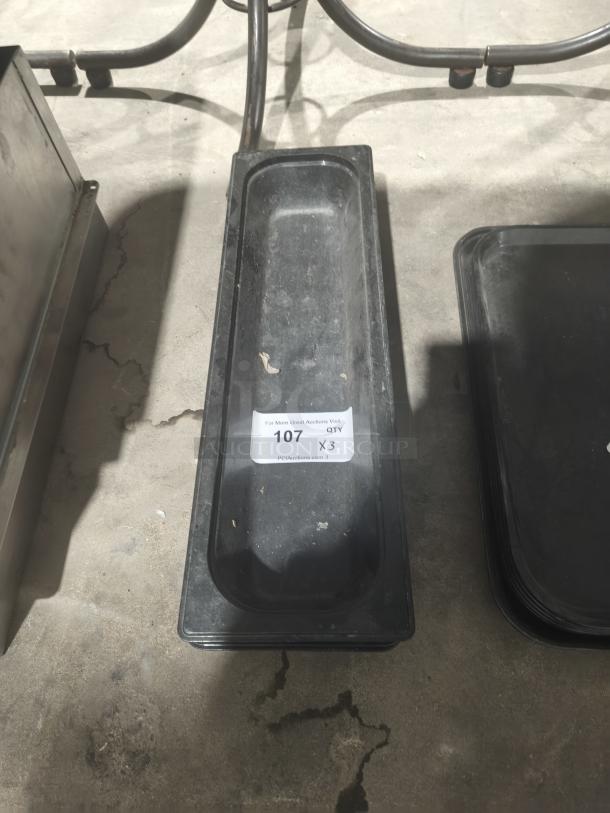 Polycarbonate 1/9-size food pan, black, with auction label "107 QTY x3," showing moderate wear.