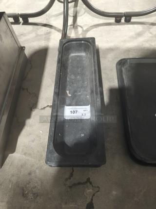 Polycarbonate 1/9-size food pan, black, with auction label "107 QTY x3," showing moderate wear.