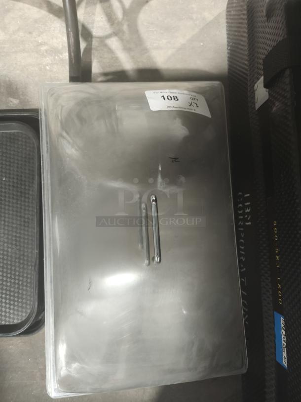 Clear acrylic buffet display dome with handle, slightly scratched surface, auction label 108 visible.