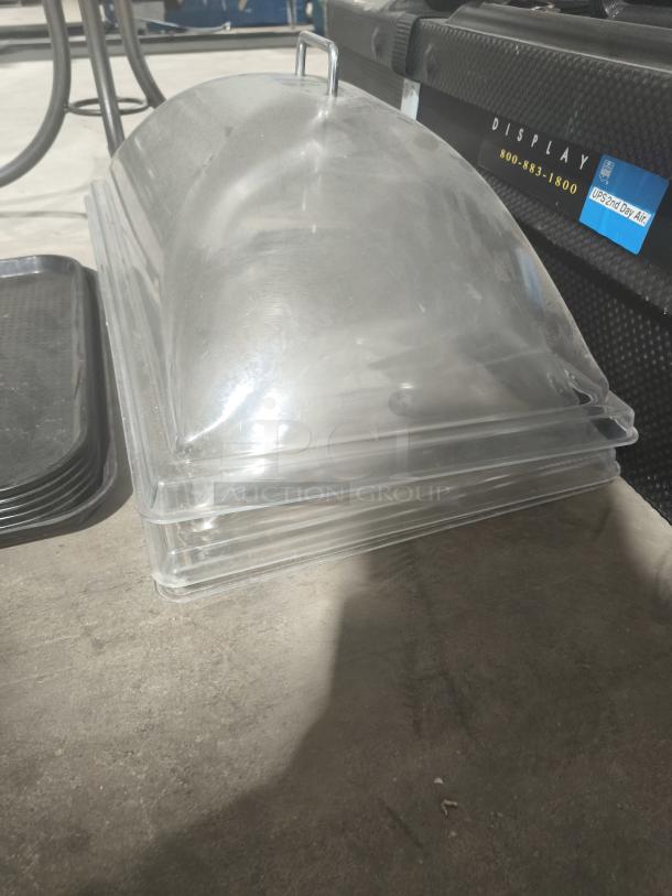 Clear acrylic buffet display dome with handle, good condition, stackable design for efficient storage.