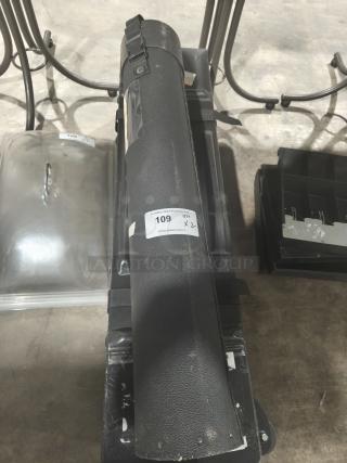 Black adjustable poster/blueprint carrying tube with strap, showing wear. Auction label marked "109" attached.