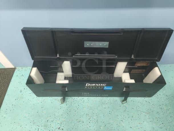 Downing Displays hard-sided trade show case, open with foam inserts, black, branded lid, showing excellent condition.