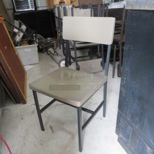 Black metal chair with gray wooden seat and backrest; sturdy frame; lightly used; suitable for various settings.