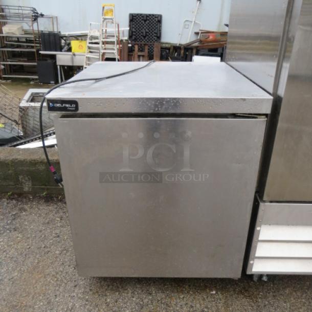 Delfield 1 Door Freezer, Model# GUF27P-S, on casters. Measures 27x30x33 inches. Includes one rack. 115 Volt, working condition.