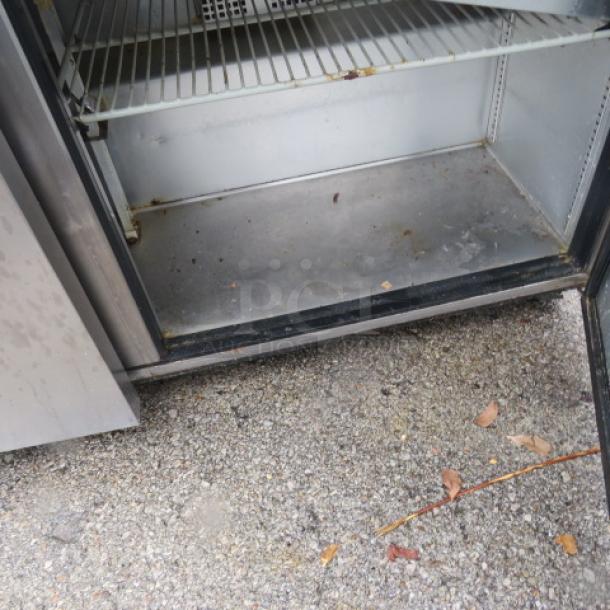 True 2-door refrigerated prep table, model TSSU-60-24M-B-ST, with rack, cutting board, on casters. Appears used, 60x34x45 inches.