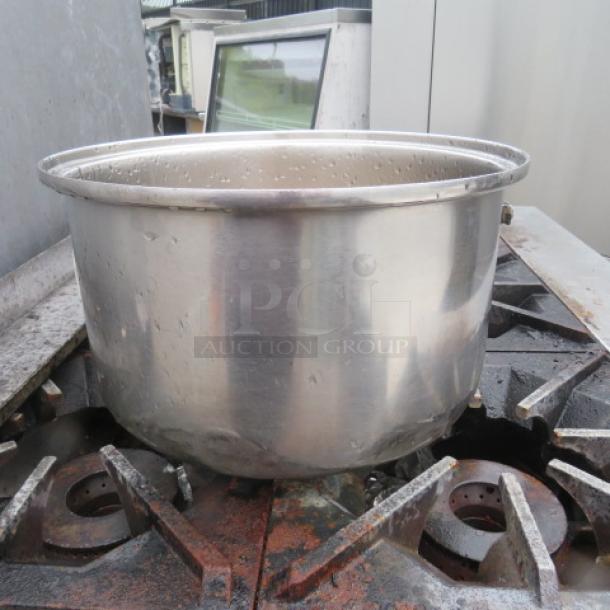 Stainless steel pot, 12.5x8 inches, polished finish, in used condition, open top, slight water spots visible.