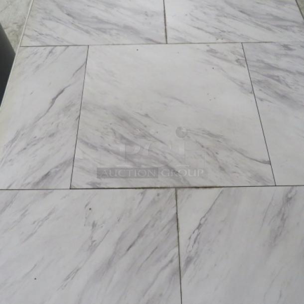 White and gray tile top table with pedestal base, featuring marble-like pattern, in good condition.