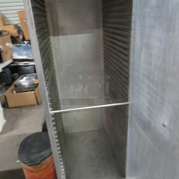 Epco aluminum holding cabinet on casters, 21x27x63 inches. Used condition, open interior with shelves. Ideal for storage.