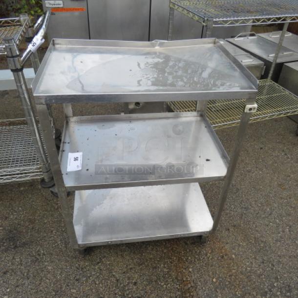 One stainless steel cart with 3 shelves on casters, 24x16x32.5 inches, used condition.