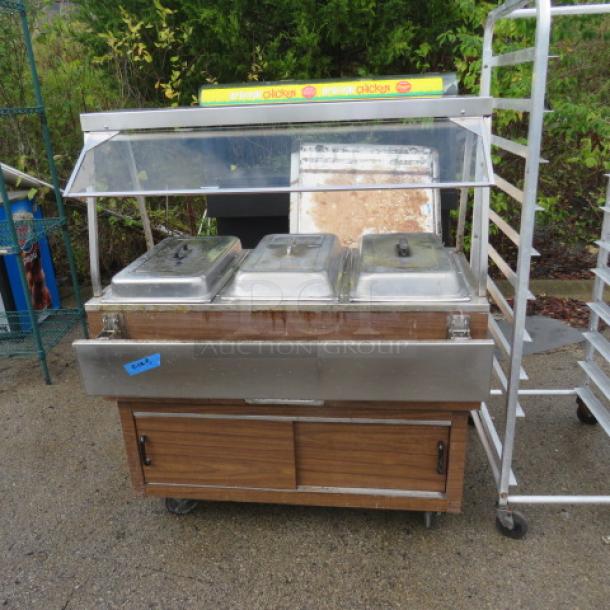 One 3-well steam table with sneeze guards on casters, Model DPAH3HE, 120V, dimensions 44.5x22.5x53.5 inches, used condition.