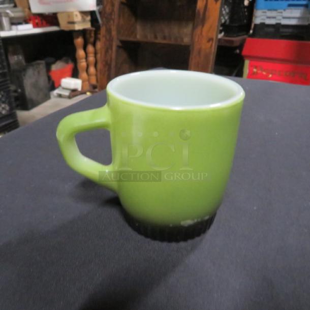 Vintage Anchor Hocking Fire King green coffee mug, excellent condition, glossy finish, mid-century collectible.