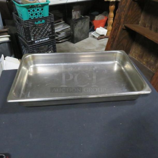 Stainless steel full-size 2.5-inch hotel pan. Used condition, with visible wear and scratches. Ideal for catering or food service.