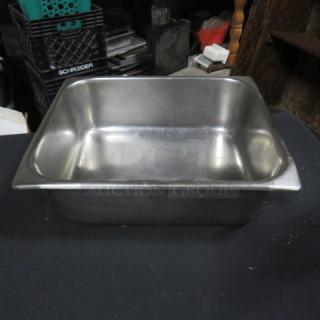 One half size 4-inch hotel pan, stainless steel, gently used, clean interior, durable, suitable for commercial kitchens.