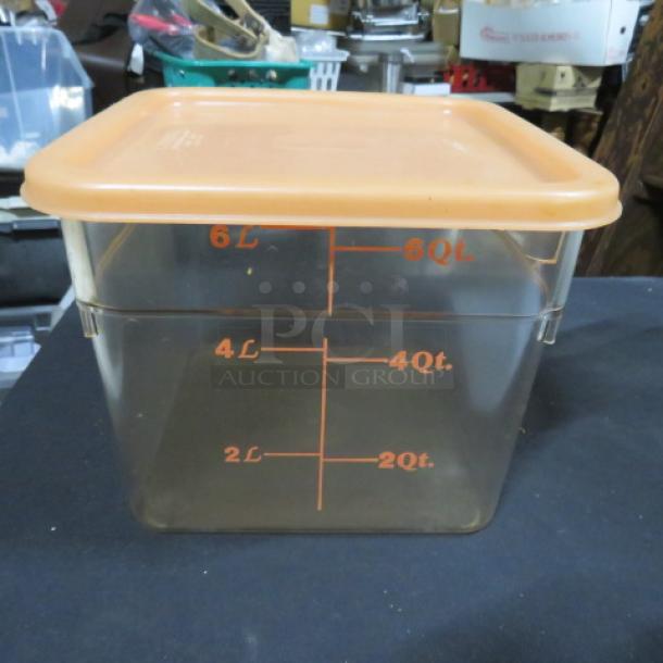 Transparent 6-quart food storage container with orange lid; features measurement markings from 2 to 6 quarts.