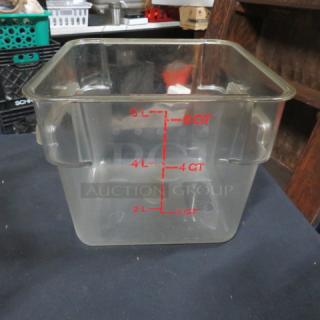 Clear 6-quart square food storage container with red quart and liter measurement markings. Clean, minimal wear.