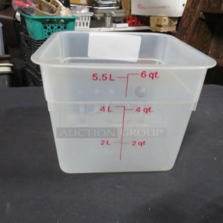 Transparent 6-quart food storage container with red measurement markings, in used condition.