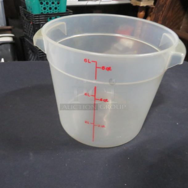 Transparent 6-quart food storage container with red measurement markings, handles, in good condition.