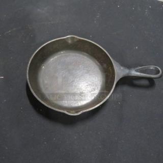 6.5-inch cast iron skillet with dual pour spouts, vintage patina, good condition, some surface wear, model 3XBID.