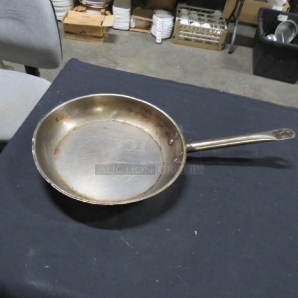 12-inch saute pan with long handle, showing wear and scratches, model 3XBID. Stainless steel, suitable for auction.