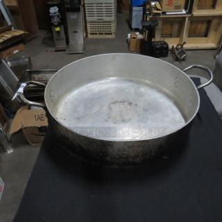 19-inch aluminum braising pan, used condition, sturdy handles, some wear visible, suitable for professional kitchens.