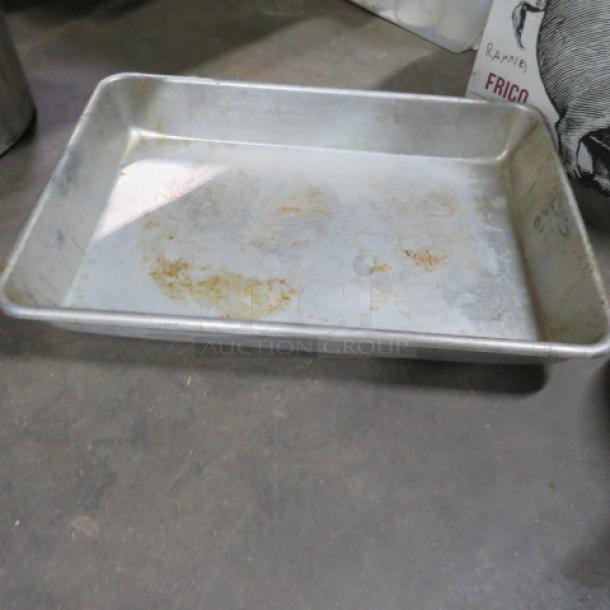 Aluminum roasting pan, rectangular, pre-owned with visible wear and discoloration. No visible brand markings.