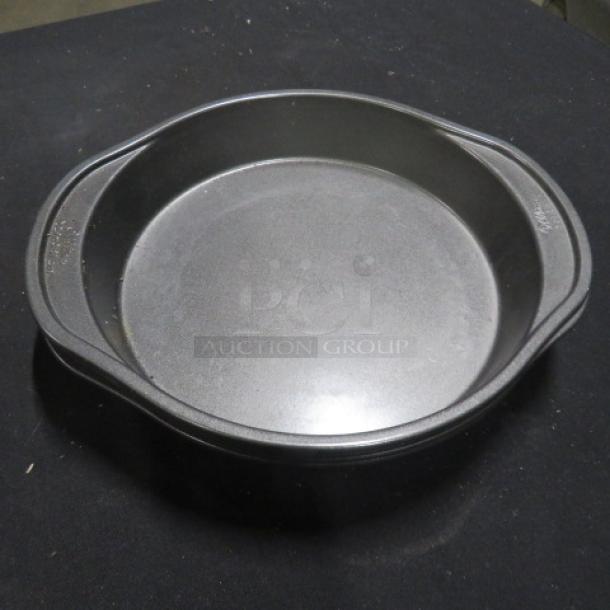 9.5 Inch Wilton Cake Pan, round metal, non-stick surface, clean, with side handles for easy grip, model 4XBID.