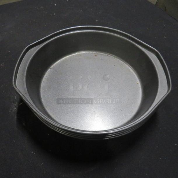 9-inch Wilton cake pan, gray, with handles, shown in good condition. Ideal for baking. Marked "5XBID."