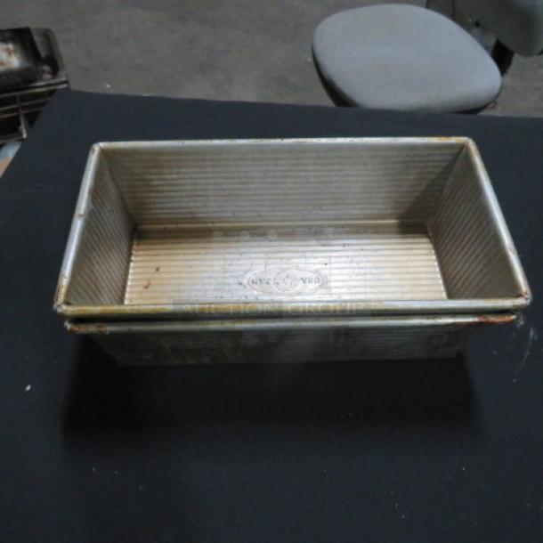 Commercial loaf pan, 10.5x5.5x3 inches, used condition, metal construction, visible manufacturer marking on base.
