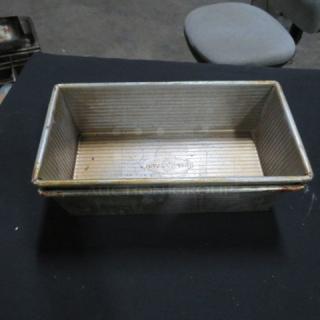 Commercial loaf pan, 10.5x5.5x3 inches, used condition, metal construction, visible manufacturer marking on base.