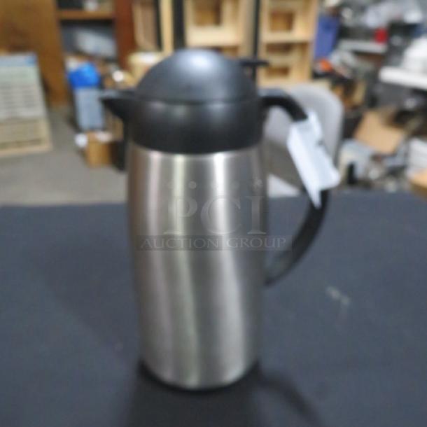 Adcraft creamer, stainless steel, black plastic handle and lid, good condition, suitable for hot and cold beverages.