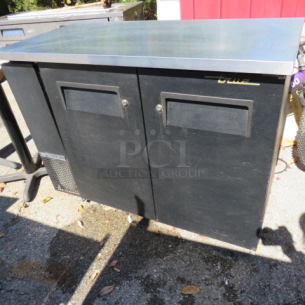 True TBB-24-48 2-door back bar cooler, stainless steel top, 49x24.5x36 inches, 115V. Black finish, working condition.