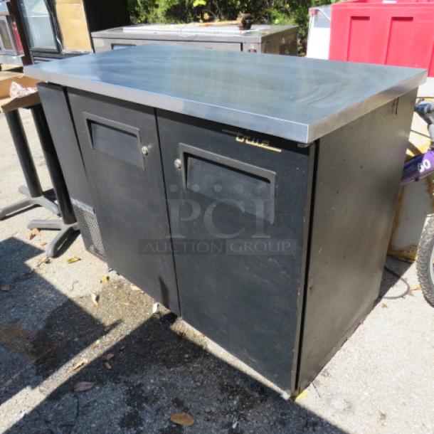 True 2 Door Back Bar Cooler, Model TBB-24-48, with stainless steel top. Dimensions: 49x24.5x36. Working condition.
