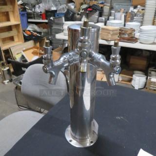Stainless steel keg tower with 3 taps, excellent condition, polished finish, suitable for bar use.