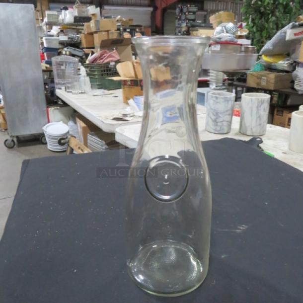 Clear 1-liter glass carafe, model 8XBID, in good condition. Simple design with round grooved detail.