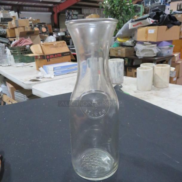 Clear 1 Liter Carafe, model 7XBID, with embossed design, excellent condition, suitable for beverages.