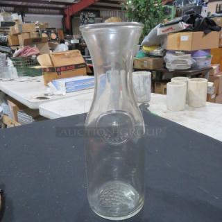 Clear 1 Liter Carafe, model 7XBID, with embossed design, excellent condition, suitable for beverages.