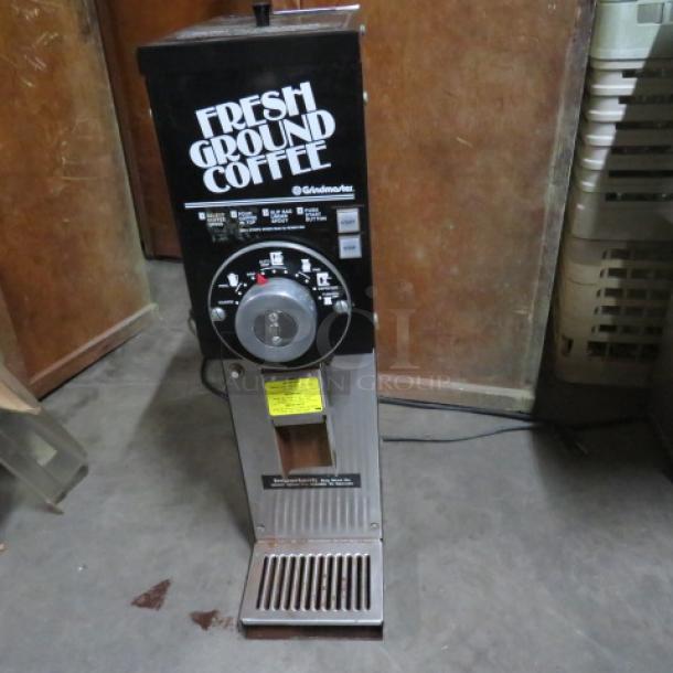 Grindmaster Model 875 coffee grinder, 115V, in used condition. Features "Fresh Ground Coffee" label, measures 7x15x27 inches.