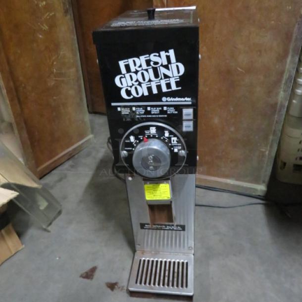 Grindmaster Coffee Grinder, Model 875, 115 Volt, 7x15x27 inches. Features "Fresh Ground Coffee" label, used condition.