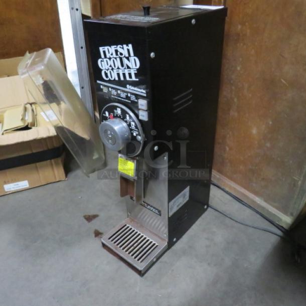 Grindmaster Coffee Grinder Model 875, 115V, black, with Fresh Ground Coffee label, 7x15x27 inches, used condition.