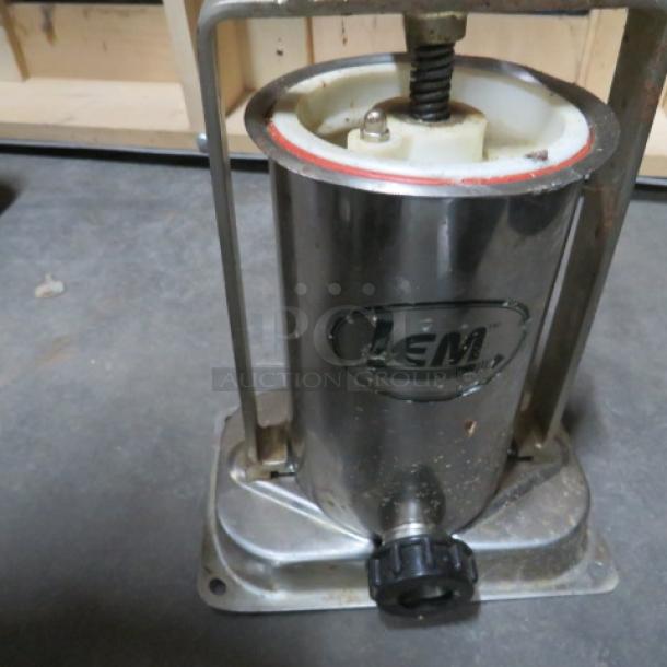 LEM Sausage Stuffer, stainless steel body, manual crank, slightly worn condition, visible branding on the side.